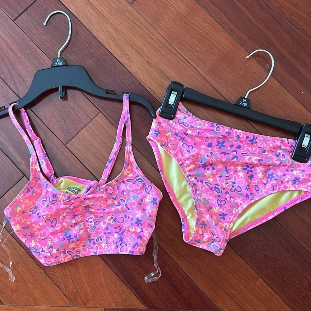 Girls set of swimsuits, pink set is a 7/8 and the one piece is a small.